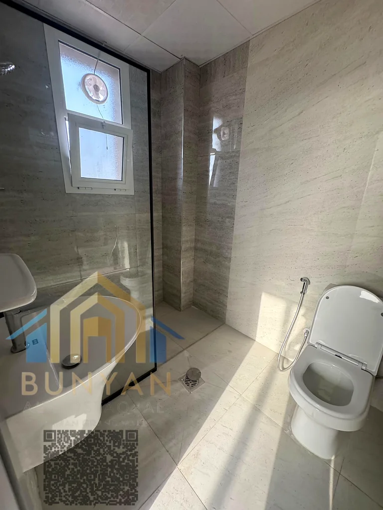 Apartment for rent in Al Rashidiya 2, Ajman, featuring 2 bedrooms, hall, 2 bathrooms, balcony, and central A/C. Prime location near Ladies Park. Annua63721053688322111