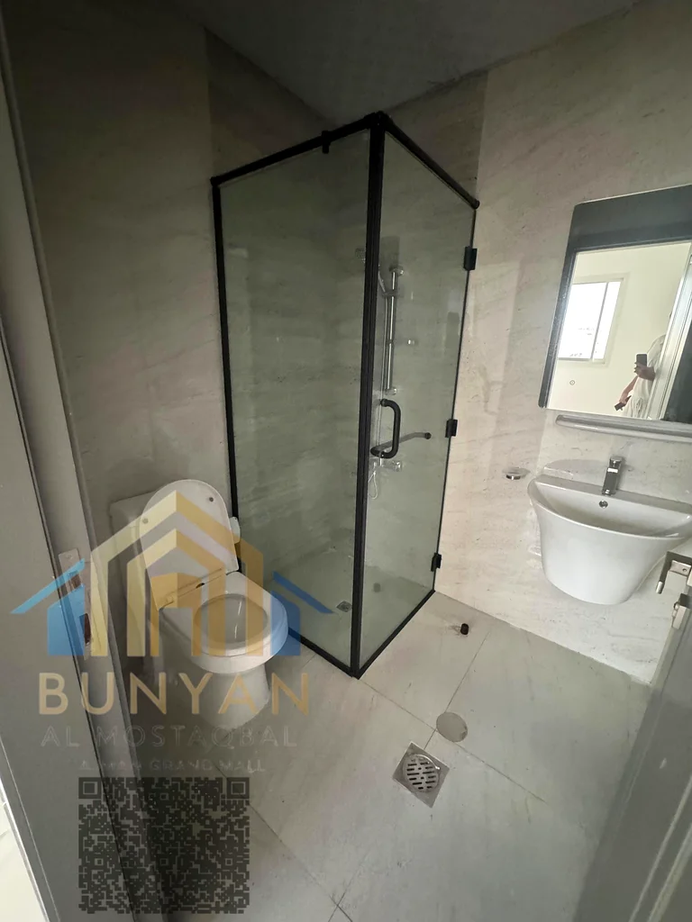 Apartment for rent in Al Rashidiya 2, Ajman, featuring 2 bedrooms, hall, 2 bathrooms, balcony, and central A/C. Prime location near Ladies Park. Annua63721053688322114