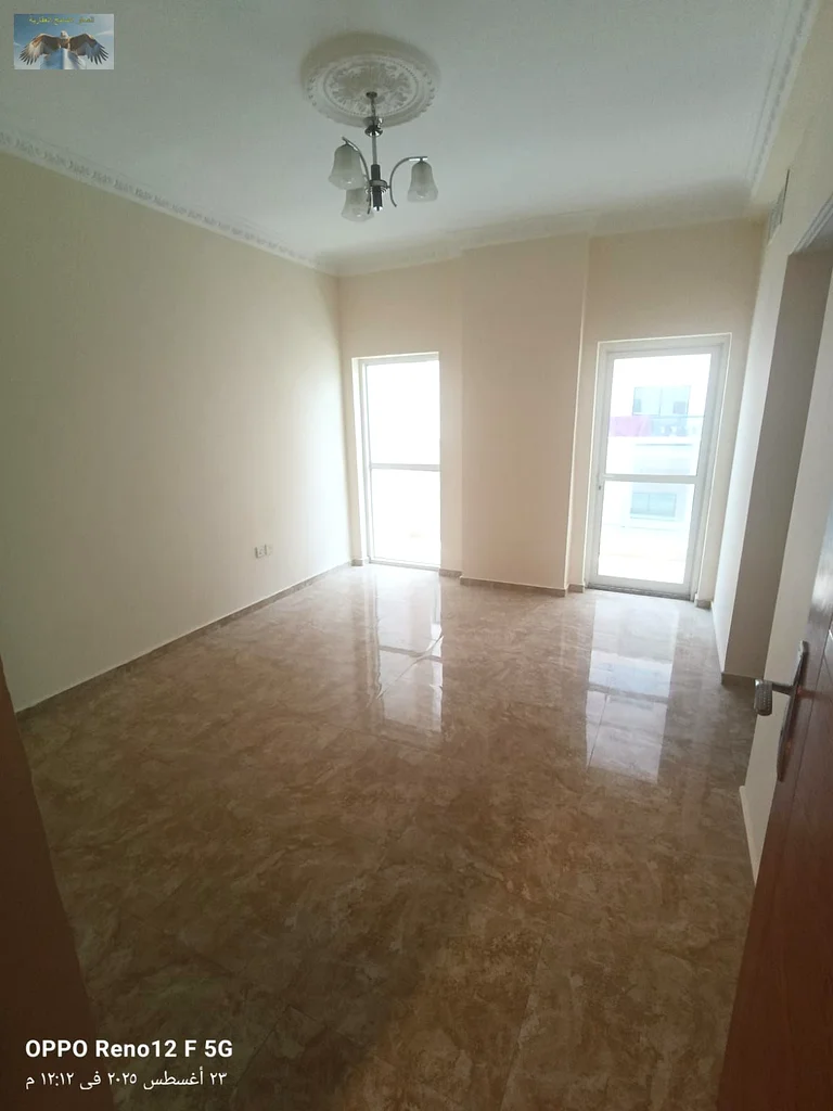 New apartment for the first tenant in Al Rashidiya 2, Ajman, two bedrooms and a hall with modern finishes, with two bathrooms, a large balcony, and bu63721701004547110