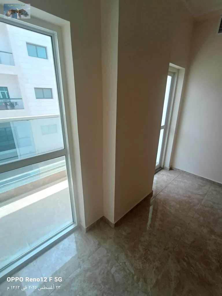 New apartment for the first tenant in Al Rashidiya 2, Ajman, two bedrooms and a hall with modern finishes, with two bathrooms, a large balcony, and bu63721701004547111