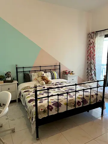 Charming IKEA Black Metal Bed Frame with Floral Bedding