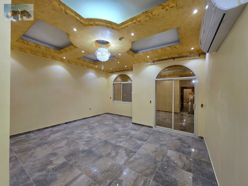 Luxury villa for rent in Al Rawda 2 in Ajman, the second plot from Sheikh Amma Street, two floors with a roof, 5 master bedrooms, a hall, a council, a63723095230977114