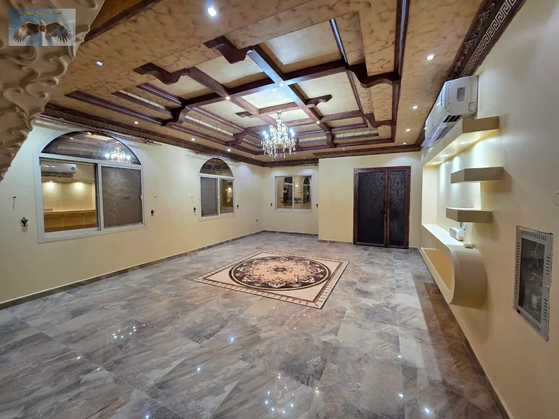 Luxury villa for rent in Al Rawda 2 in Ajman, the second plot from Sheikh Amma Street, two floors with a roof, 5 master bedrooms, a hall, a council, a63723095230977112