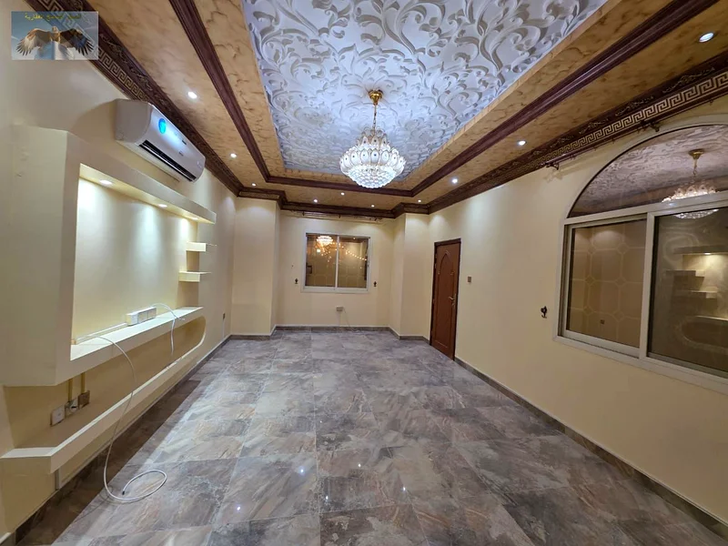 Luxury villa for rent in Al Rawda 2 in Ajman, the second plot from Sheikh Amma Street, two floors with a roof, 5 master bedrooms, a hall, a council, a63723095230977113