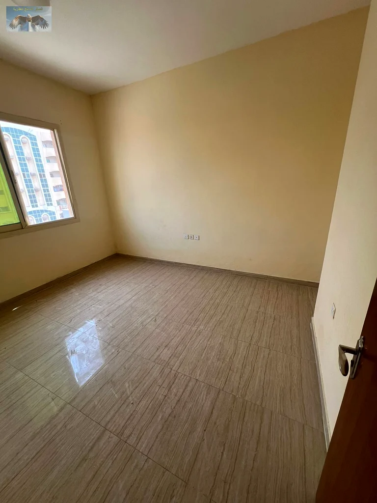 First-class apartment for rent in Al Rashidiya 2 - 2 bedrooms, a spacious hall with 2 bathrooms and a large balcony, built-in wardrobes and high-end f63721614318467112