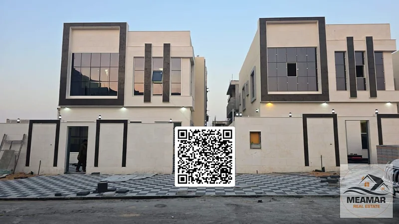 For sale, a luxurious villa in Al Helio, Ajman, 5 master bedrooms, a living room, and a hall, located in a strategic location near Mohammed bin Zayed63906384341890110