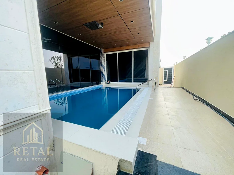 Luxury villa for sale in Al Helio Center Ajman on a prime corner location with private pool, garden, spacious layout, and full ownership services63906124026498114