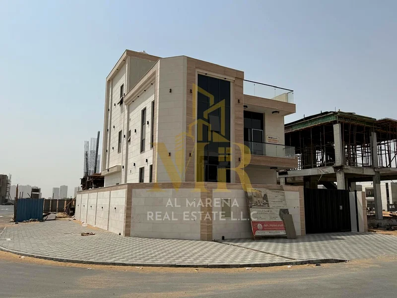For sale, a corner villa in Al Hiliyo 2 - Ajman, two floors and a roof in a prime location with excellent space. Includes registration and ownership f63906123979395111