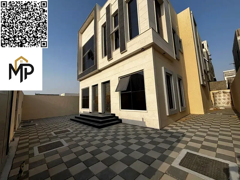 For sale, a luxurious villa in Al Helio, Ajman, 5 master bedrooms, a living room, and a hall, located in a strategic location near Mohammed bin Zayed63907043796227113