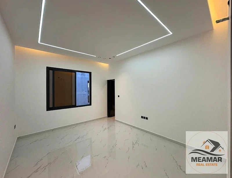 A luxurious, modern villa in Al Helio 1, featuring a stunning view and a spacious built-up area. The villa consists of two floors, ground and first, w63892471909634113
