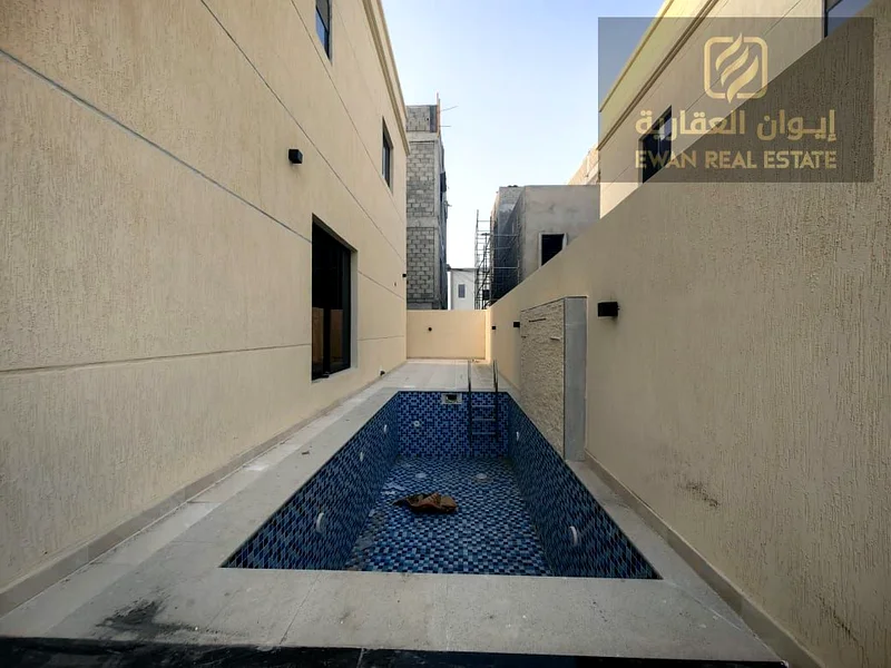For Sale | Luxurious corner villa in Al Helio, Ajman, super deluxe finishing + private pool, prime location: - Near the exits from Sharjah and Dubai .63909116861443113