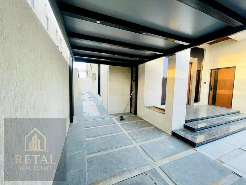 Luxury villa for sale in Ajman, Al Bahia area – 5 master bedrooms, majlis, living room, fitted kitchen, maid’s room, central AC, super deluxe finish63882823548035113