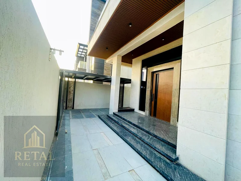Luxury villa for sale in Ajman, Al Bahia area – 5 master bedrooms, majlis, living room, fitted kitchen, maid’s room, central AC, super deluxe finish63882823548035112