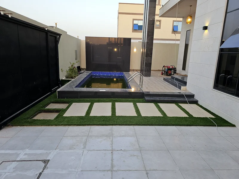 Villa for sale in Ajman, Al Helio 2 area, including registration and ownership fees, consisting of 4 master bedrooms with a swimming pool, freehold fo63909552278145112