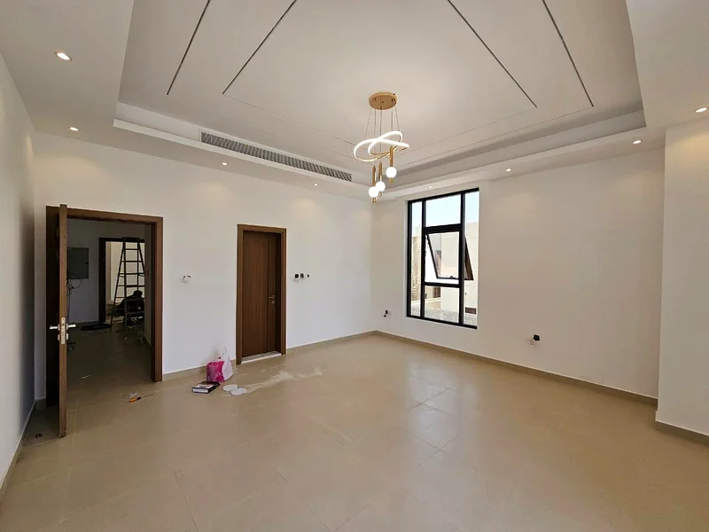 Villa for sale in Ajman, Al Bahia area, including central air conditioning, consisting of 5 master bedrooms, a living room, a hall, and indoor and out63883087795457113