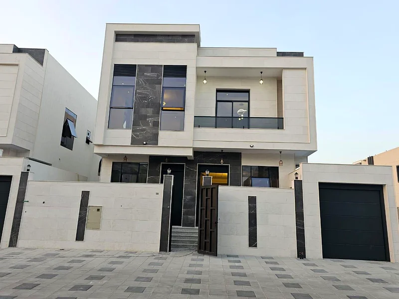 Villa for sale in Ajman, Al Bahia area, including central air conditioning, consisting of 5 master bedrooms, a living room, a hall, and indoor and out63883087795457111