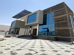 Two villas for sale in Al Houchi, near Emirates Road. Ground floor + first floor Each villa consists