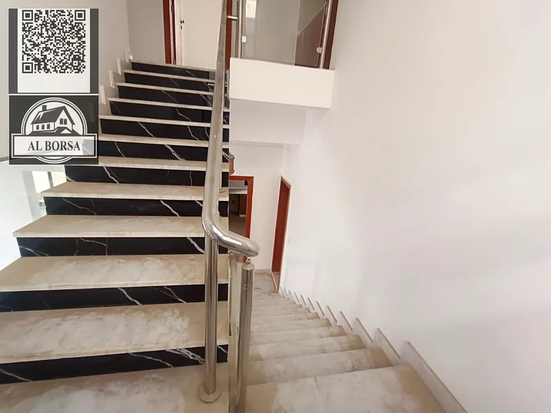 For sale, a villa in Al Helio 2, Ajman, consisting of 3 bedrooms, a hall, a majlis, and a maid’s ro63911404093955114