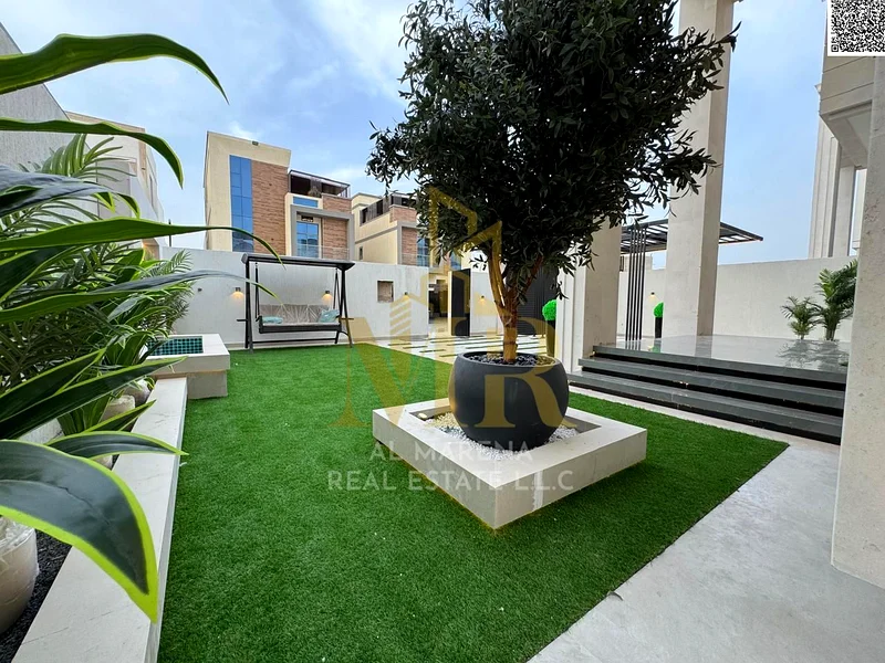 For sale, a luxurious villa in Al Bahia - Ajman | Two floors + roof | 5 master bedrooms + majlis + 2 halls + front yard + roof seating area | Land are63883873956482110