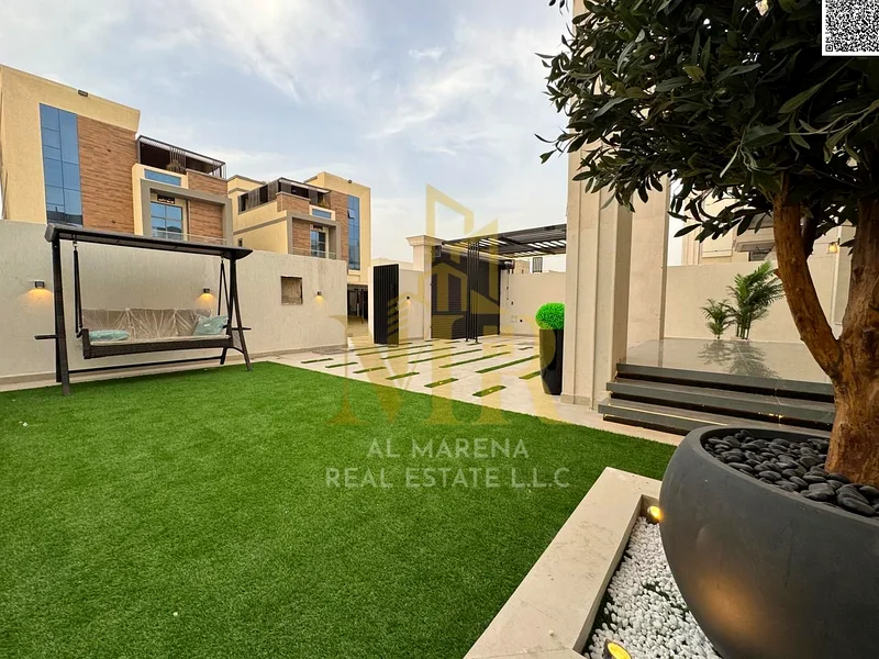 For sale, a luxurious villa in Al Bahia - Ajman | Two floors + roof | 5 master bedrooms + majlis + 2 halls + front yard + roof seating area | Land are63883873956482111
