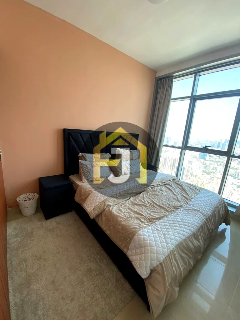 Own two bedrooms and a hall for sale in the Corniche Residence Towers, Ajman, with a full view of the city and the creek63870459184130112