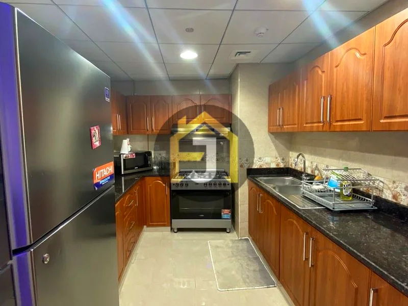 Own two bedrooms and a hall for sale in the Corniche Residence Towers, Ajman, with a full view of the city and the creek63870459184130111