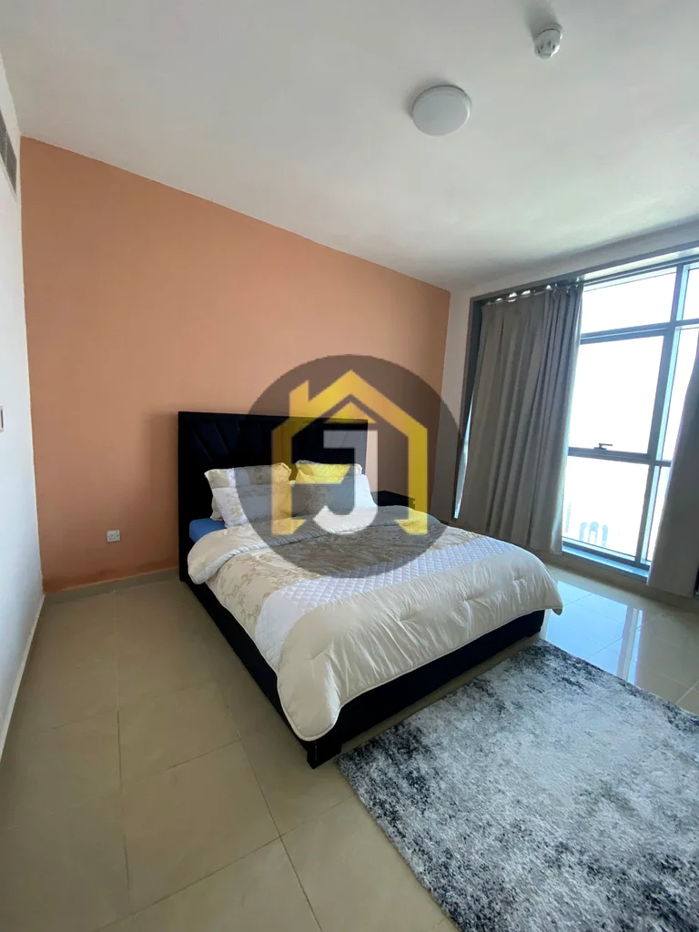 Own two bedrooms and a hall for sale in the Corniche Residence Towers, Ajman, with a full view of the city and the creek63870459184130113