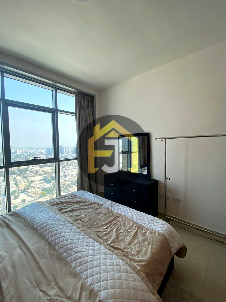 Own two bedrooms and a hall for sale in the Corniche Residence Towers, Ajman, with a full view of the city and the creek63870459184130114