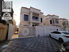 For sale, a villa in Al Helio 2, Ajman, consisting of 4 master bedrooms, a majlis, a hall, and a mai