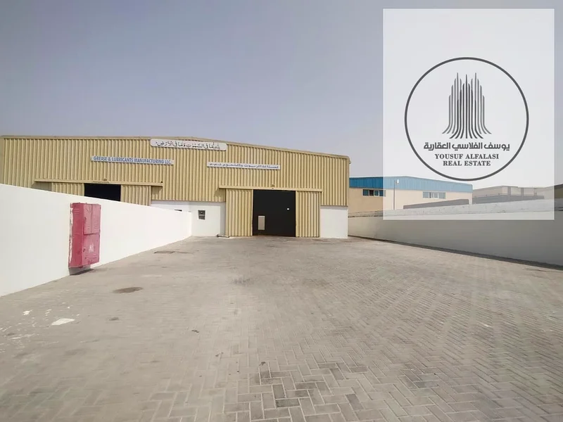 Warehouse with a fence for rent in Al Sajaa Industrial City - prime location, area of ​​10,000 square feet64057583513474110
