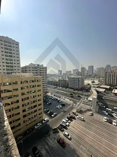 For sale, a two-bedroom apartment with a hall next to Mega Mall in the Emirate of Sharjah, freehold