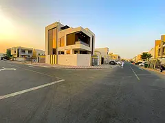 Corner villa for sale in Ajman, Al Zahia area, with an indoor swimming pool, 4 master bedrooms, a mo
