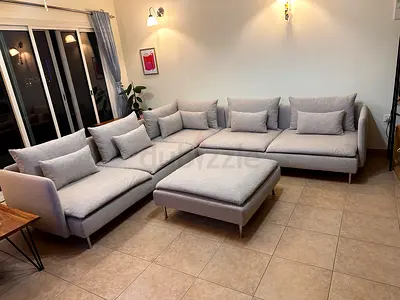 Ikea soderhamn corner sofa with ottoman in beige color.