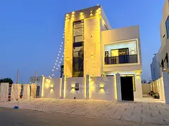 A luxurious, modern, 3-story villa in Al Helio, Ajman, on a main street with spacious areas and high