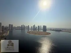 An apartment with a distinctive view of Al Khan Lake and a side open view in the Emirate of Sharjah,