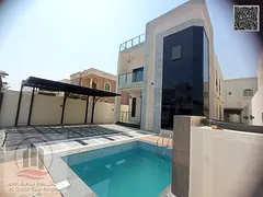 For sale, a villa in Ajman, Al Rawda, 5 master bedrooms, a living room, a swimming pool, and a maid&