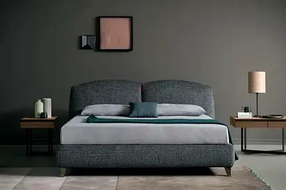 Indulge in a restful nights sleep on this plush gray bed, complemented by modern decor