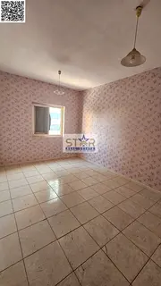 A room and a hall for annual rent in Ajman, spacious with a balcony.