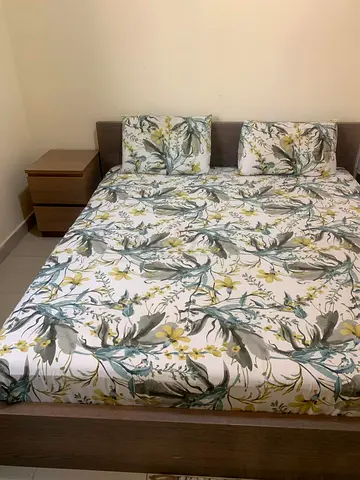 IKEA bed with mattress and side table