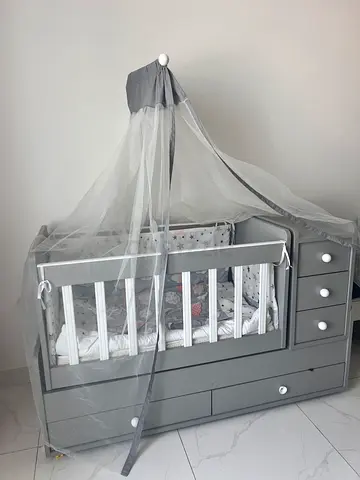 Stylish Grey and White 4 months used crib with ample storage.