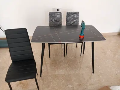 Brand new dining table with 4 chairs available