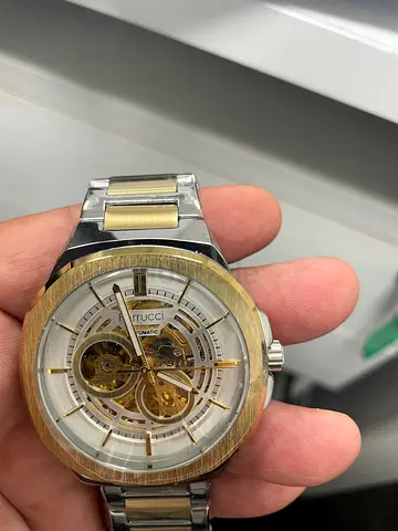 Elegant Silver and Gold Automatic Watch with Skeleton Dial