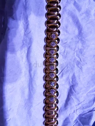 GOLD AND DIAMOND BRACELETS  18K THE MODEL CATERPILLAR  9 DIAMONDS, EACH STONE 033 CR, TOTAL WEIGHT -