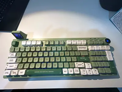 Green RT100 Mechanical Keyboard RGB lights, screen and noise adjusting wheel.