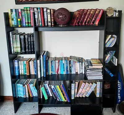 Dark wood bookshelf with space for TV