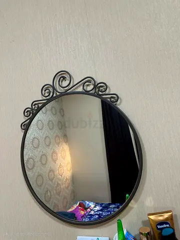 Elegant Round Wall Mirror with Decorative Scroll Design