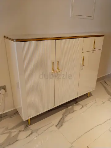 Sleek White Cabinet with Gold Accents