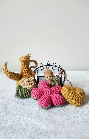 Charming Crocheted Baby Figurine with Vibrant Flowers