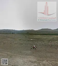 .Four residential plots of land in Masfout, Block 8, on three corner streets, two of which are paved