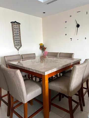 A beautiful dining table marble design squared shape 8 high chairs beautiful brown color
